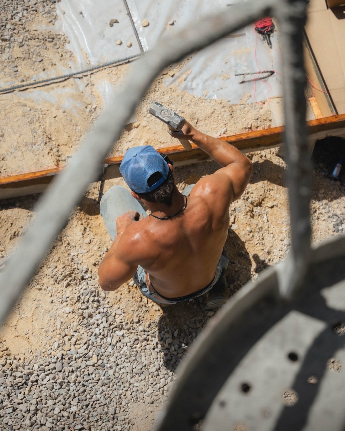 Crew member setting forms with a sledgehammer